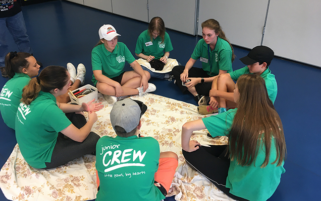 junior crew members sitting in a circle